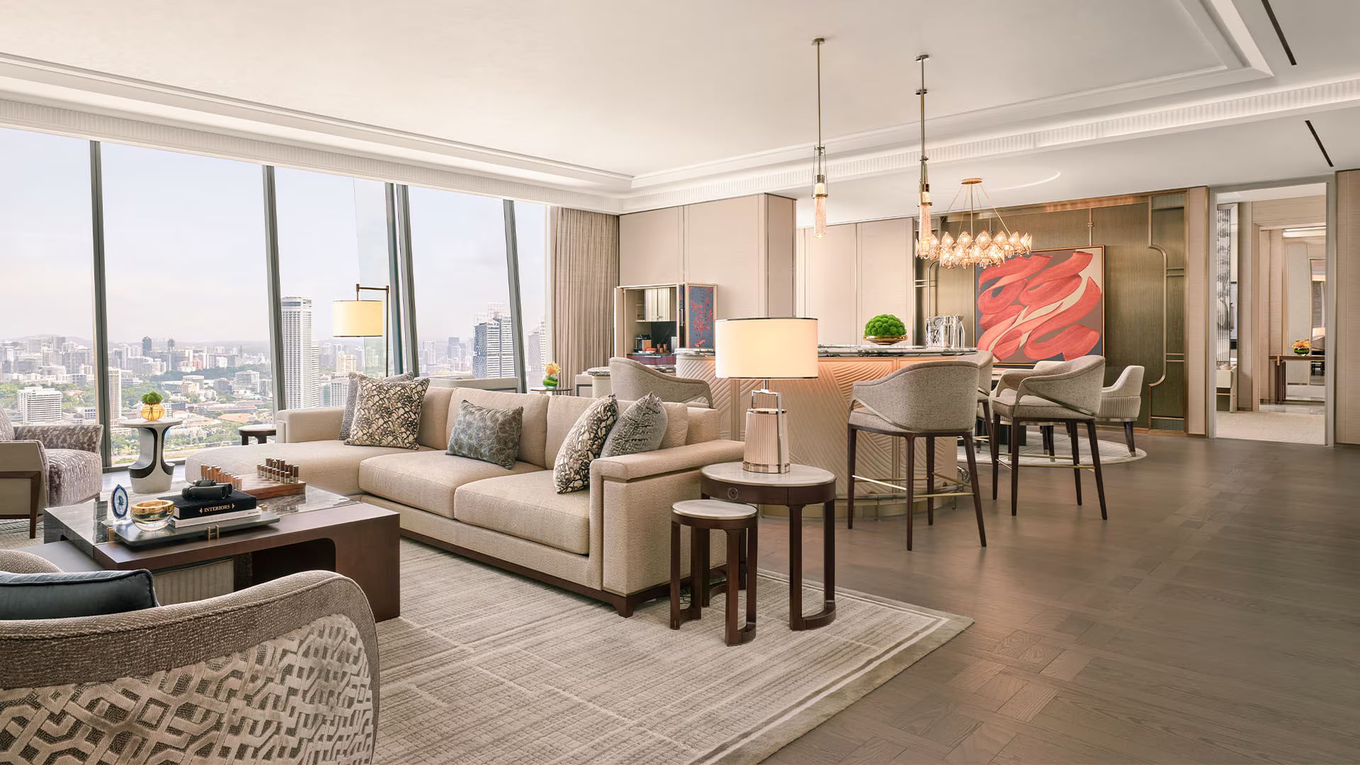 The Presidential Suite living room at Marina Bay Sands: pale sofas, a long dining table, and a large abstract painting in soft blues and corals against floor-to-ceiling city views